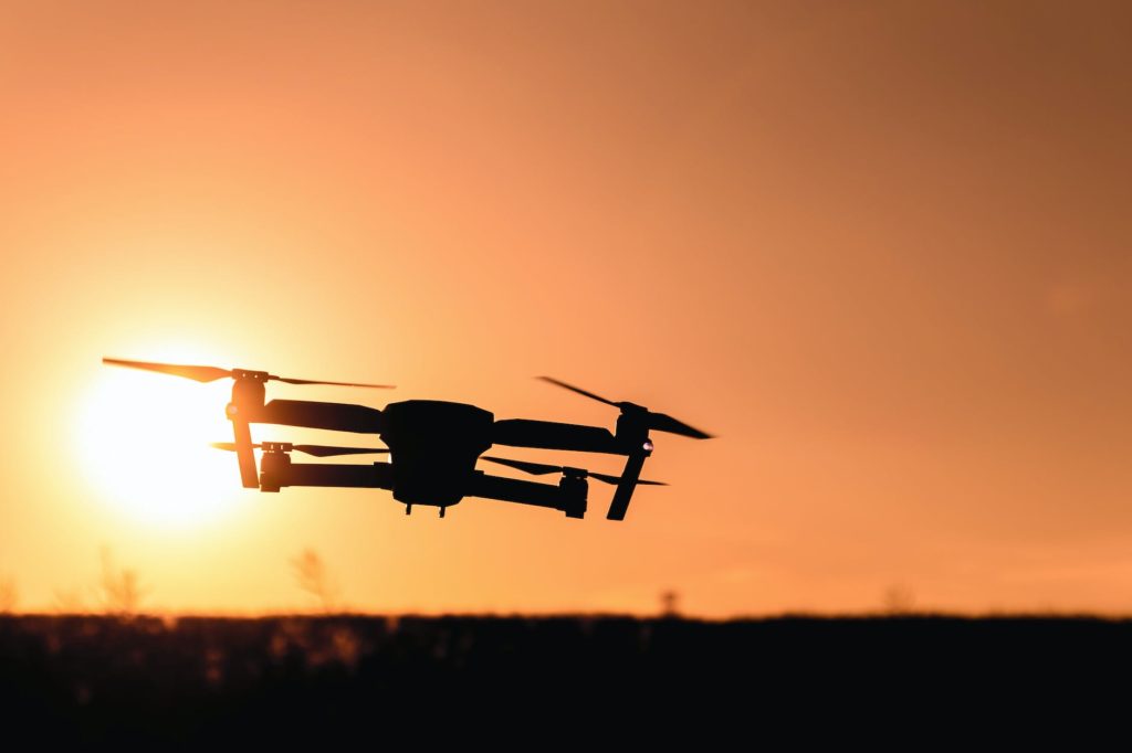 silhouette of camera drone flew in mid air